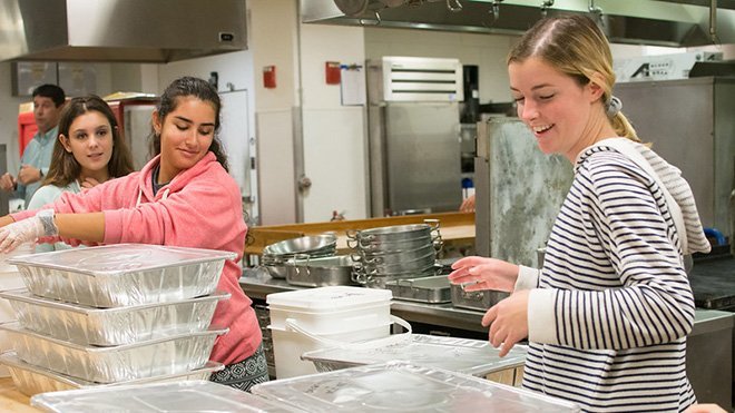 Students package uneaten food to donate to woman and children's shelters.